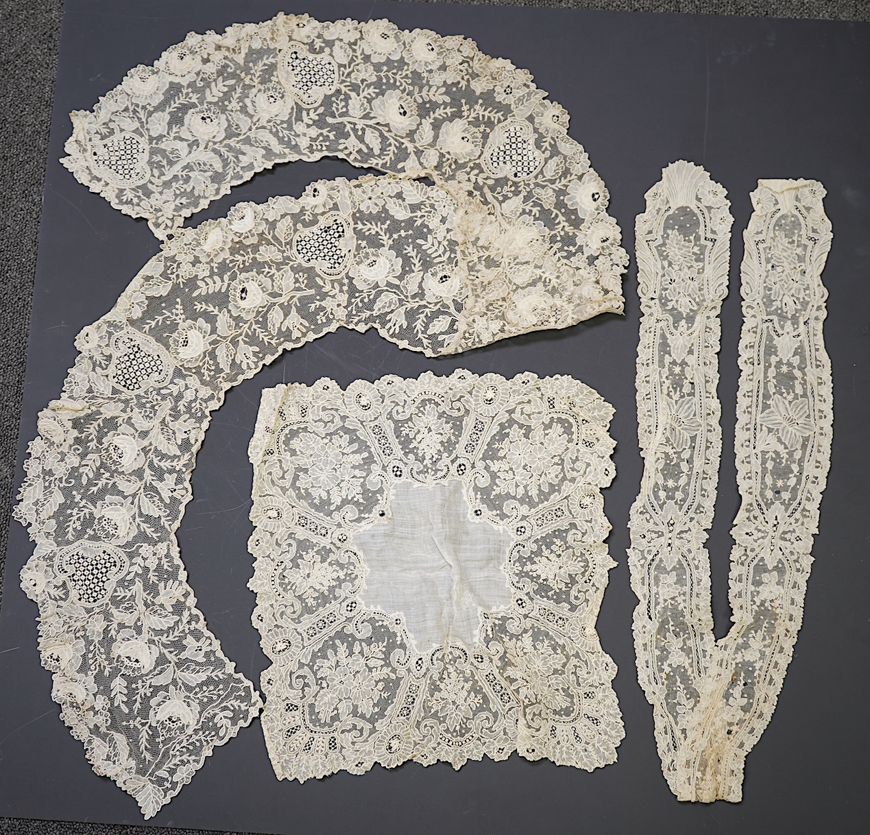 A 19th century Brussels Point de Gaz needle lace collar, lappet and wedding hankie, possibly part of a trousseau. The collar having thirty four needle lace raised flower heads within the design. The collar 100cm long x 1